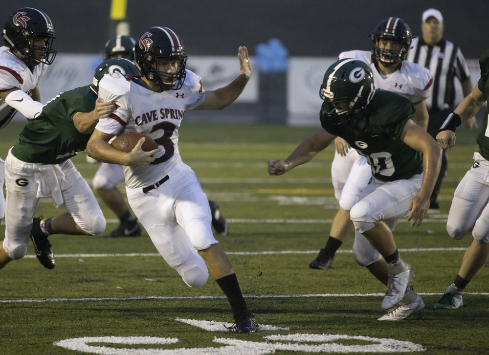 Cave Spring's (3) Lucas Duncan prepares to stiff arm Glenvar's (20) Christian Smith as (11) Cody Gibson tries to bring him down.
